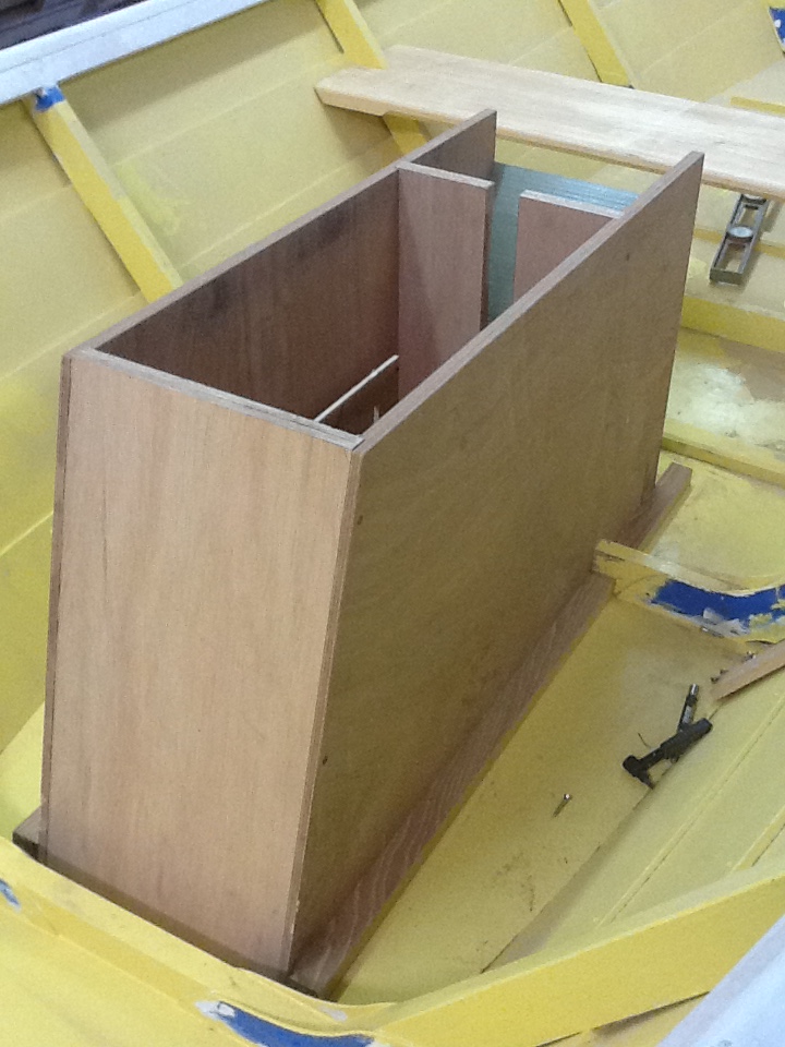 Jumping ahead…a couple coats of leftovers for primer and the ongoing plans for installing a steerable, electric pod driver motor in a well, which could be raised for trailering and beaching – what a mouthful. Shown is the ¾” meranti plywood motor well, roughly fashioned with motor mock-up set in box.