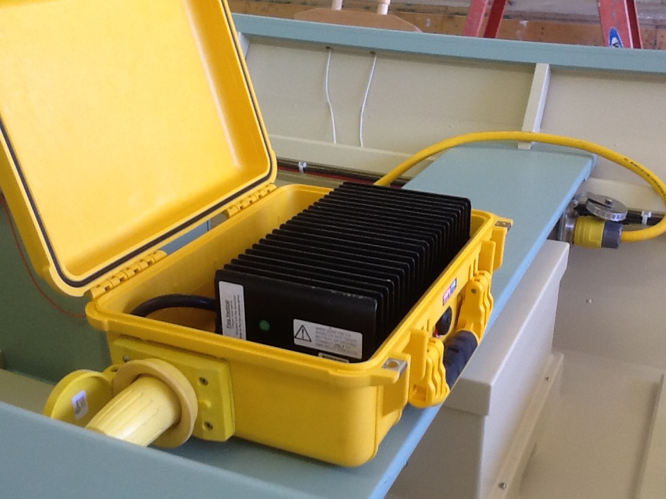 A waterproof pelican box houses a lithium ion battery charger – fitted with standard shoreside cable adapters. Shown here on board, you can take it anywhere.