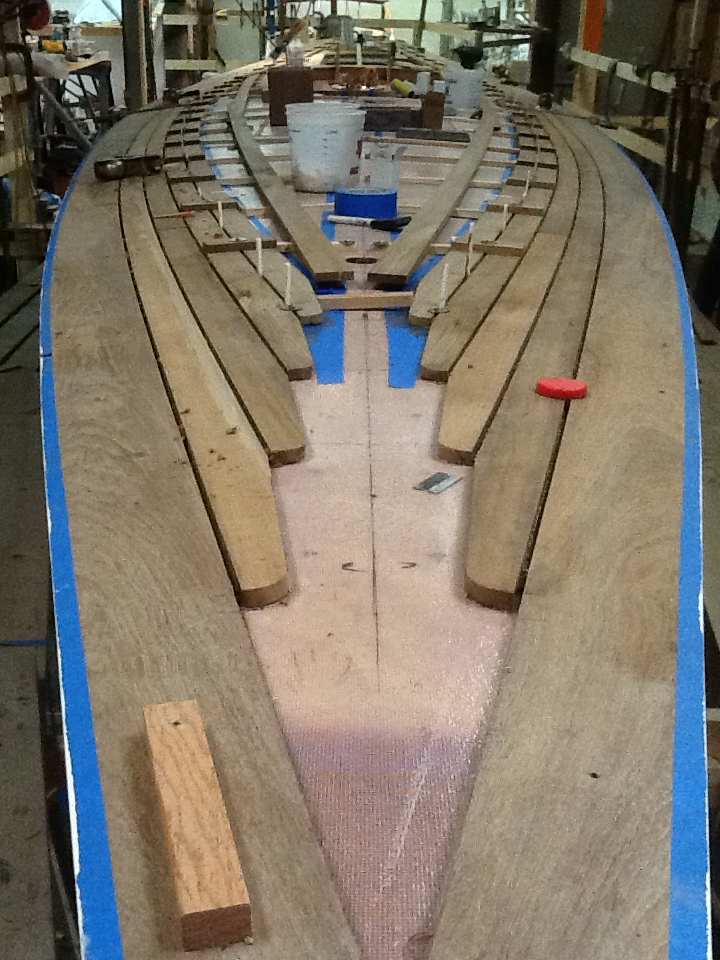 Teak over plywood deck ... paying deck seams ... no fasteners used.