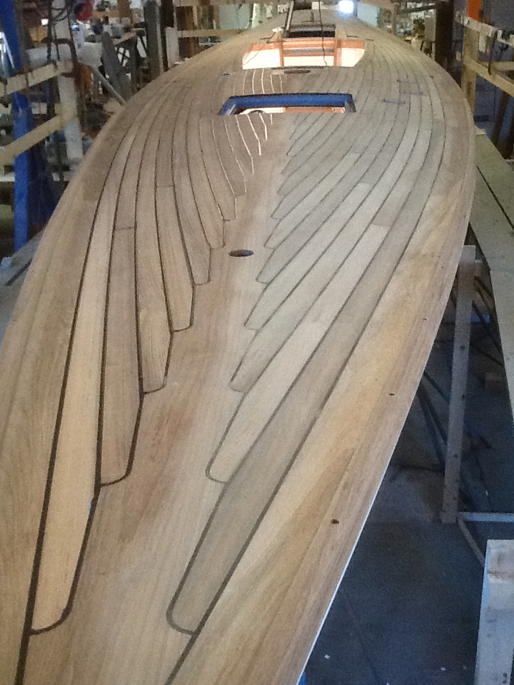 Teak over plywood deck ... paying deck seams ... no fasteners used.